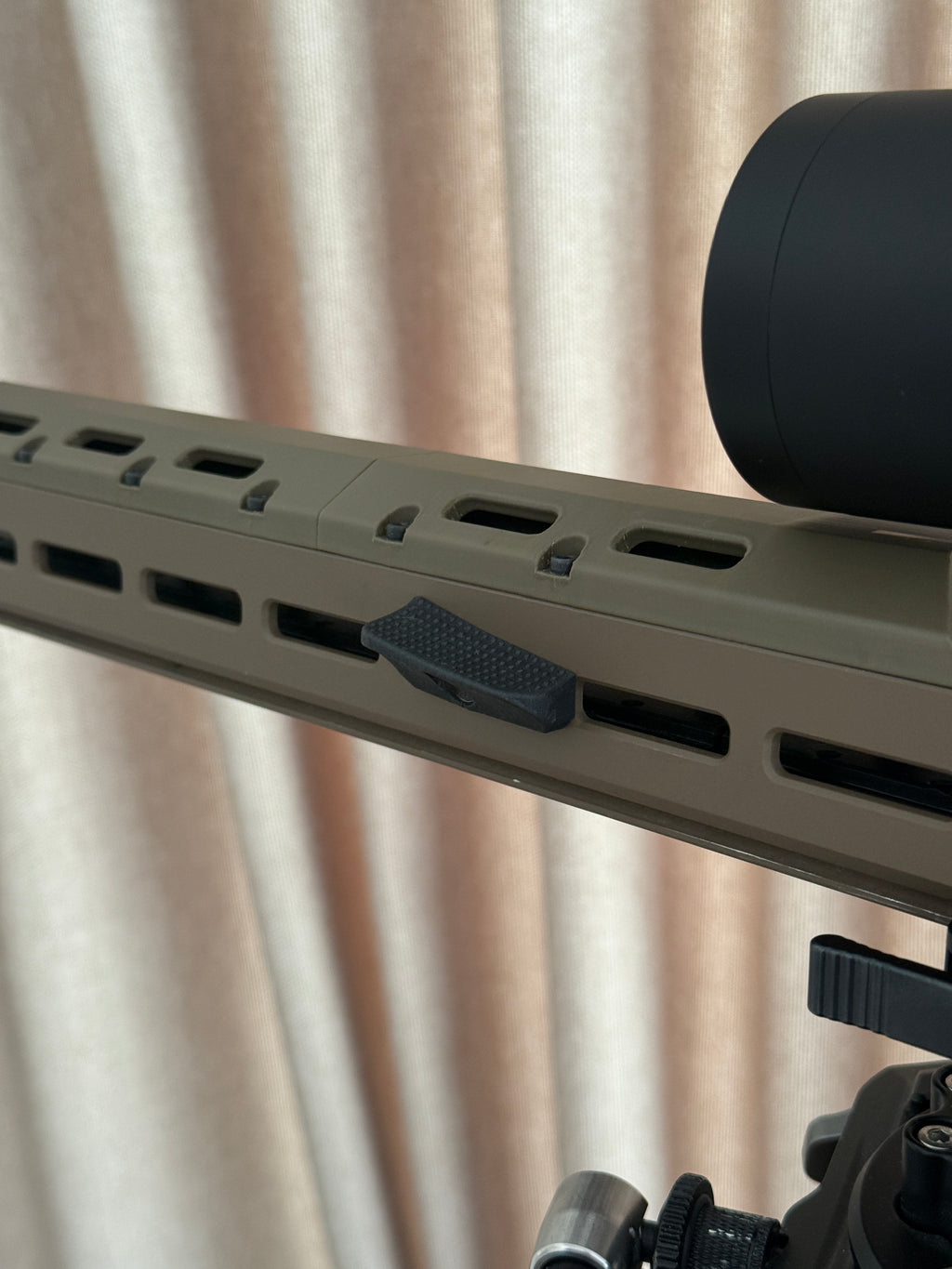 M-Lok forward thumb rest.