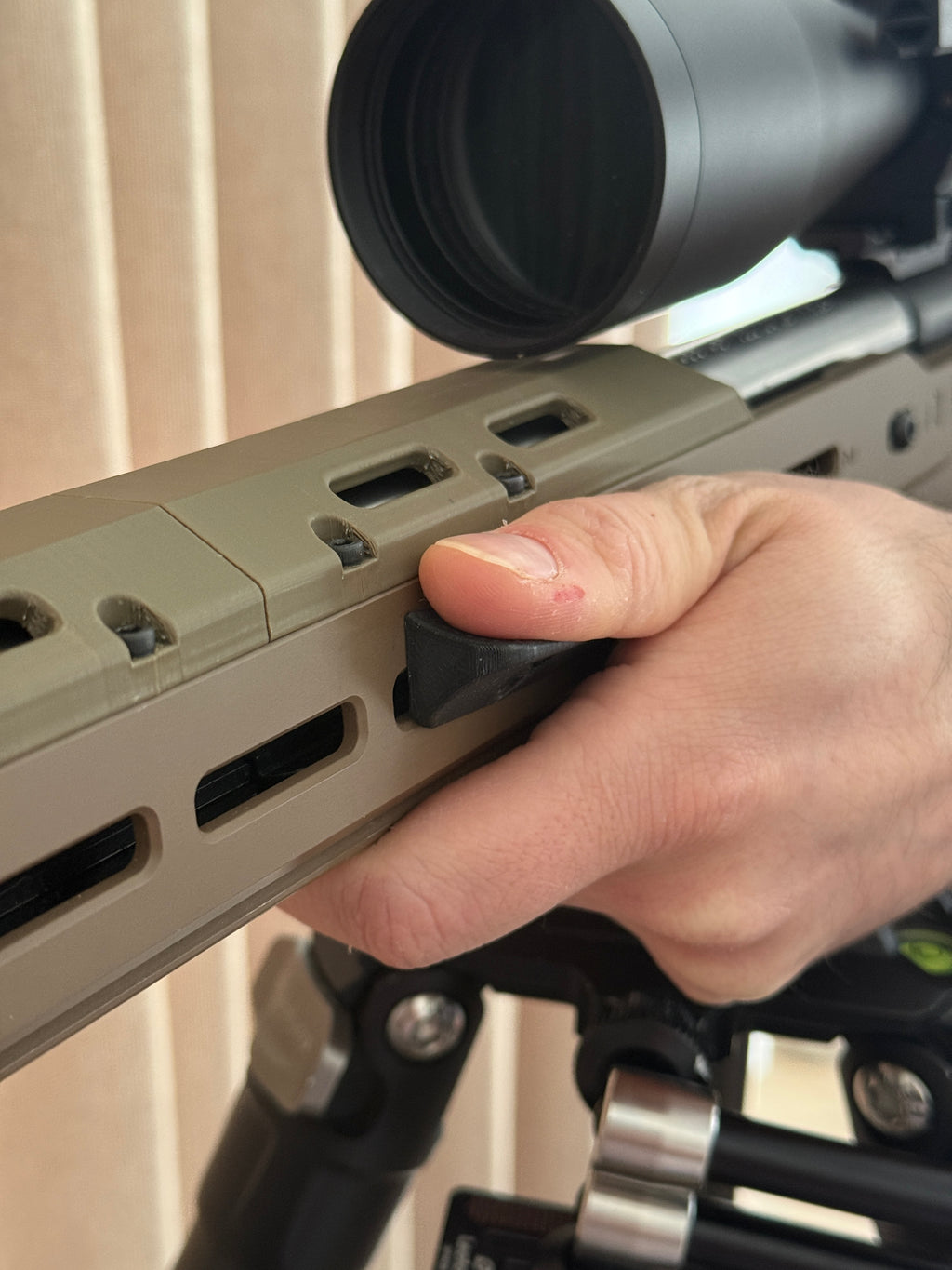 M-Lok forward thumb rest.